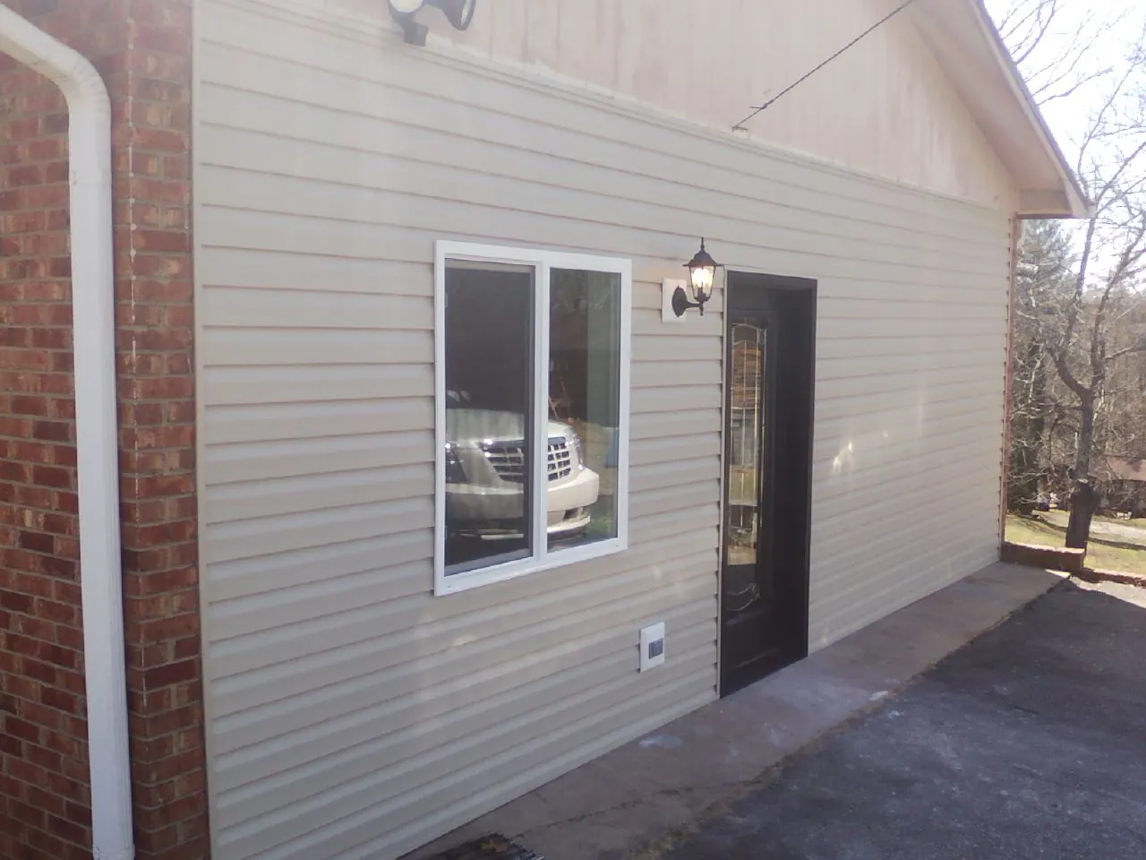 New vinyl siding and entry door on a room addition in Warrenton